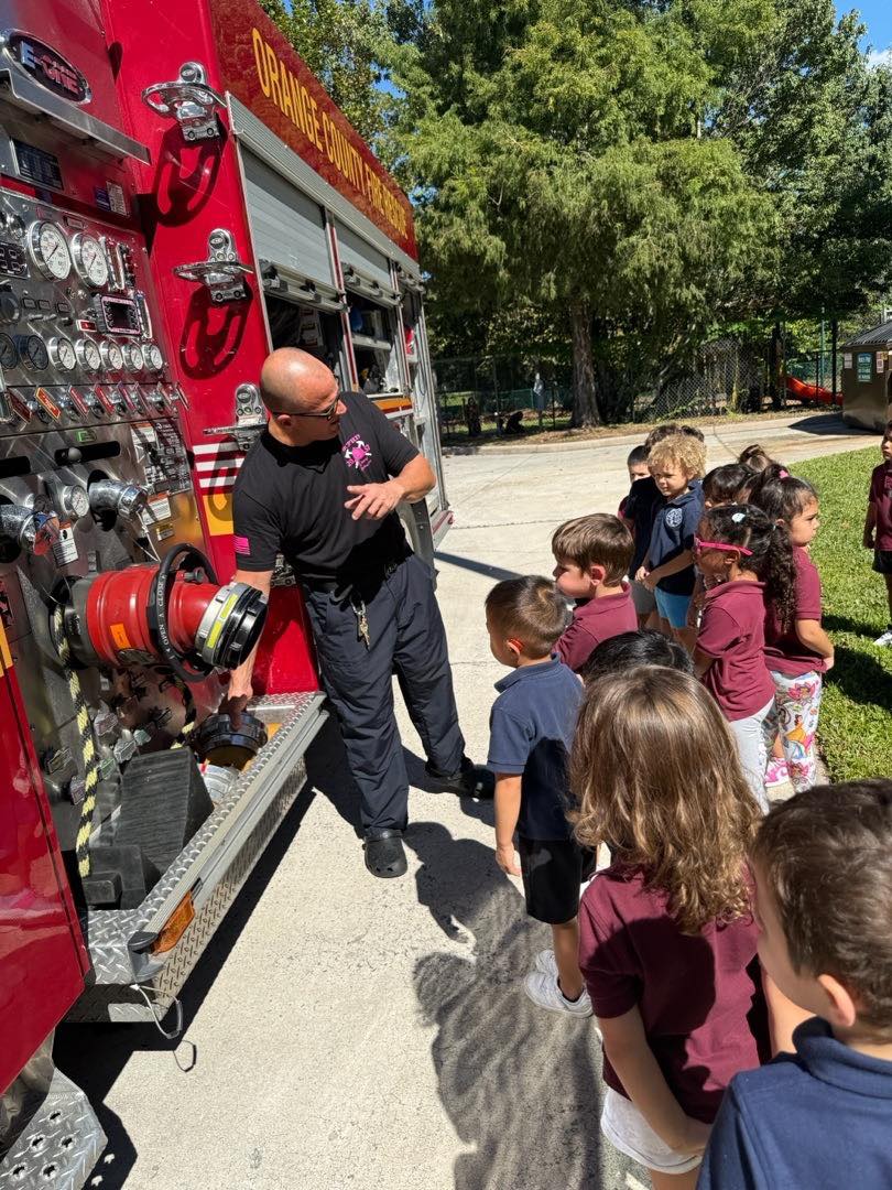 Local firefighters and their fire truck visiting the children at Monarch